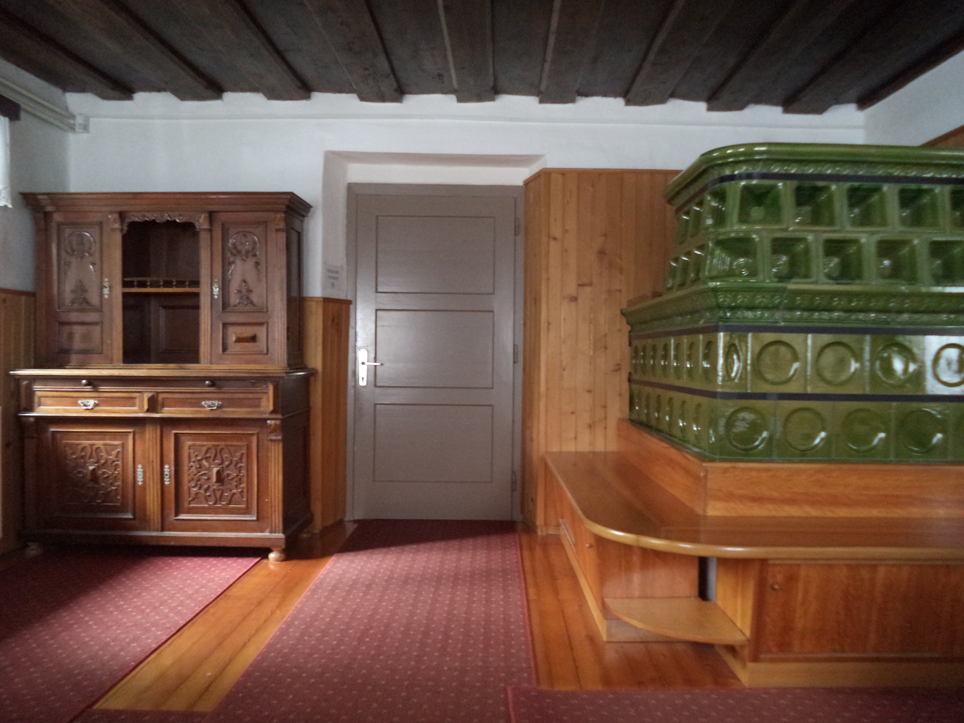 The living room has a large stove that warms the house during cold winters (rustic apartment).