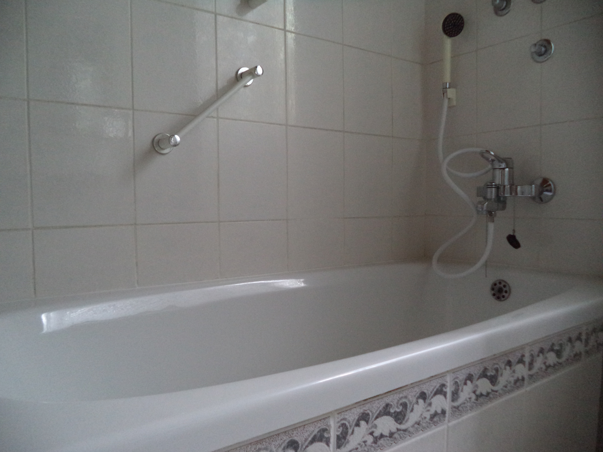 The bathtub in the bathroom.